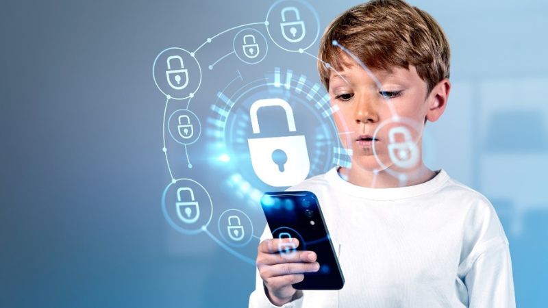 boy on cell phone with padlocks floating around it