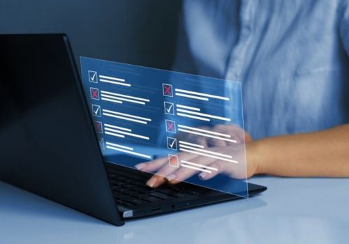 woman typing on a laptop that shows alerts of red x's and green checks