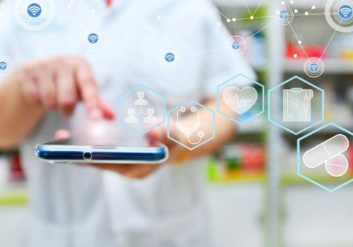 pharmacist using a tablet behind the counter
