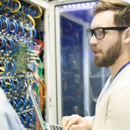 IT professional conducting a cyber audit in a server room