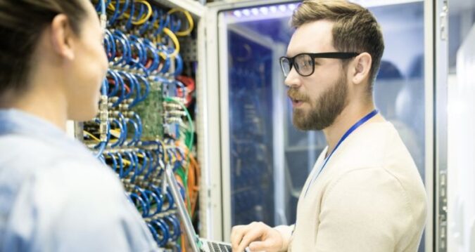 IT professional conducting a cyber audit in a server room