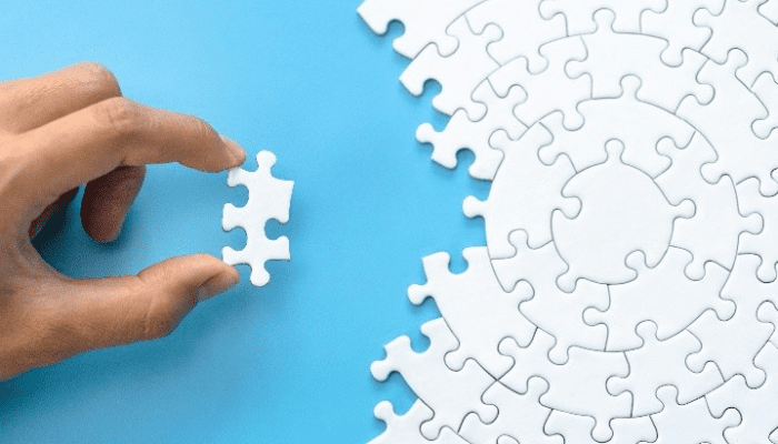 a hand placing in a puzzle piece